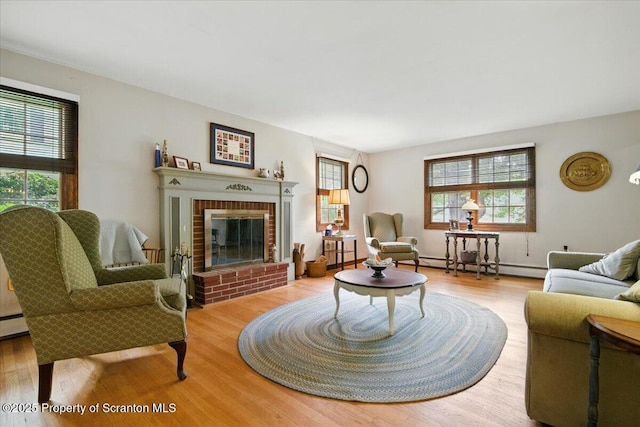 104 Sturbridge Rd, Clarks Summit, PA 18411 - living room featuring baseboard heating, wood finished floors, and a fireplace