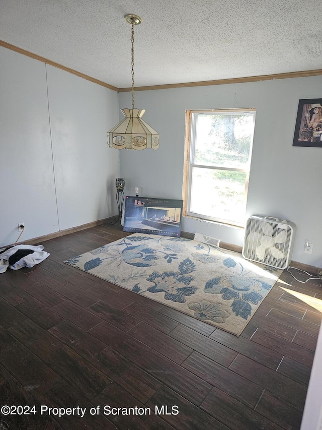 dining area featuring a textured ceiling, dark hardwood / wood-style floors, and ornamental molding