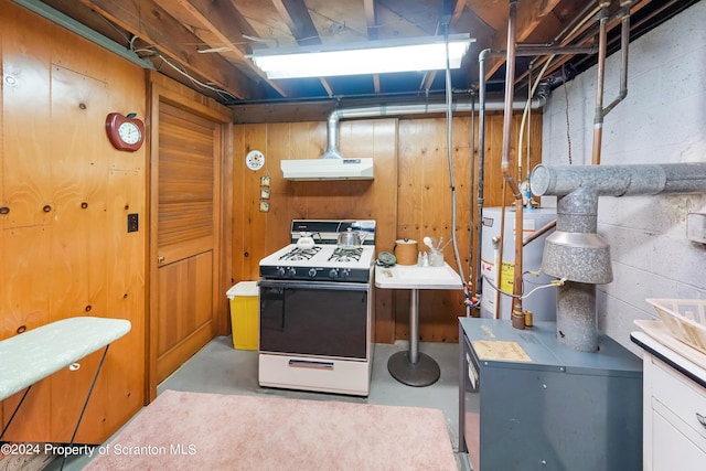 interior space featuring gas water heater and wooden walls