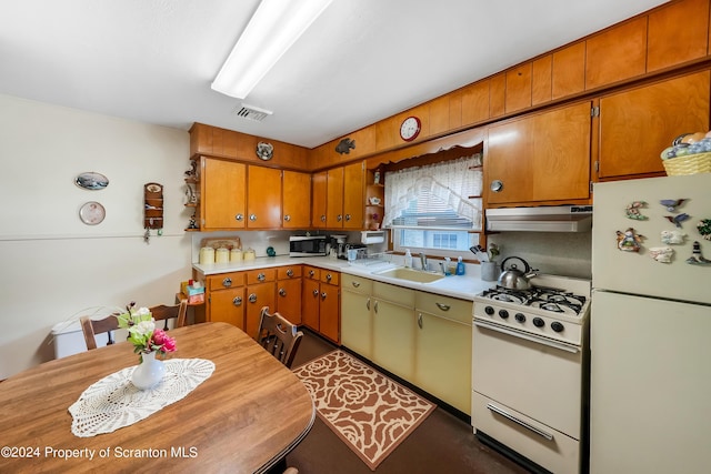 kitchen featuring white appliances and sink