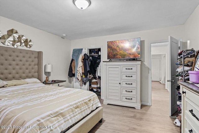 bedroom with a closet and light wood-type flooring