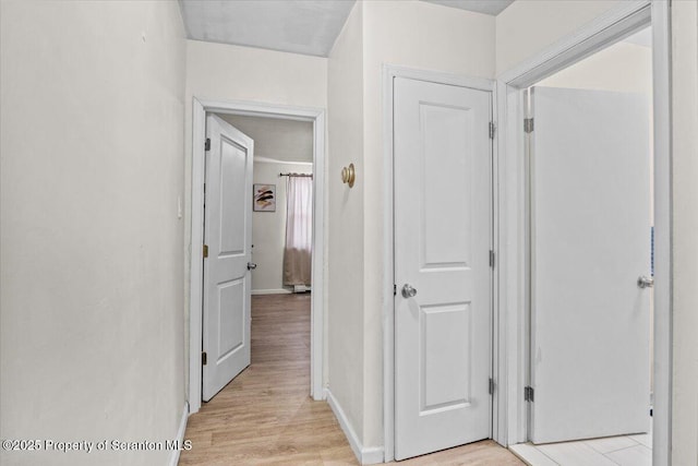 corridor featuring light hardwood / wood-style floors