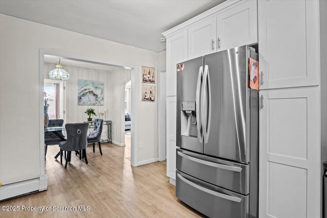 kitchen featuring white cabinetry, stainless steel fridge, and light hardwood / wood-style floors