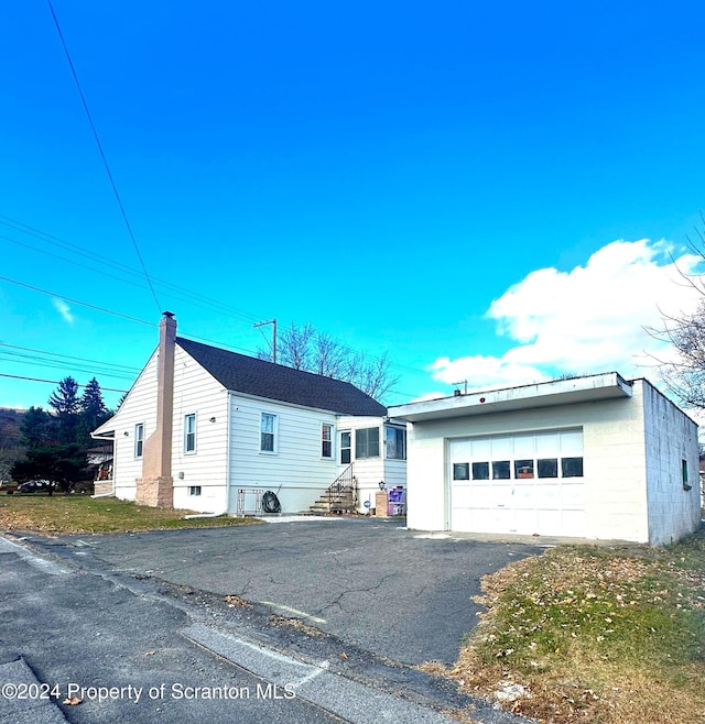 view of front of property with an outbuilding and a garage