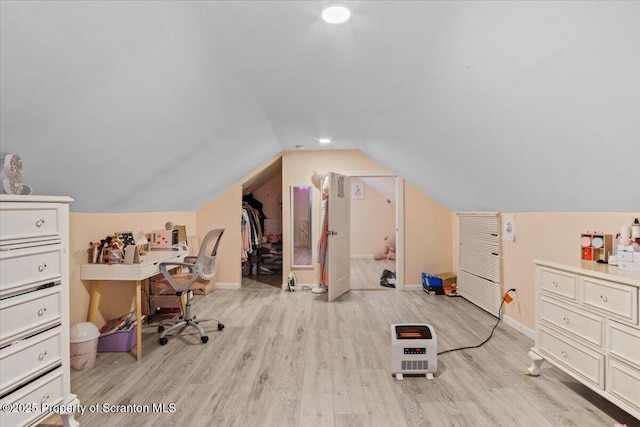 home office with vaulted ceiling and light wood-type flooring