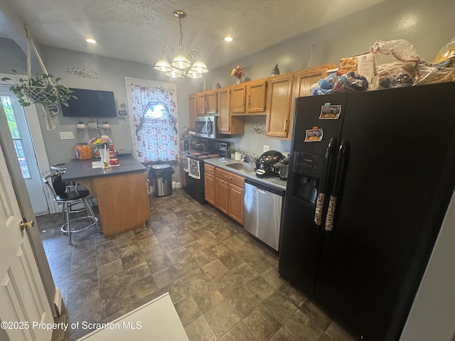1008 Crown Ave, Scranton, PA 18505 - kitchen with black appliances, a chandelier, a textured ceiling, dark countertops, and a sink