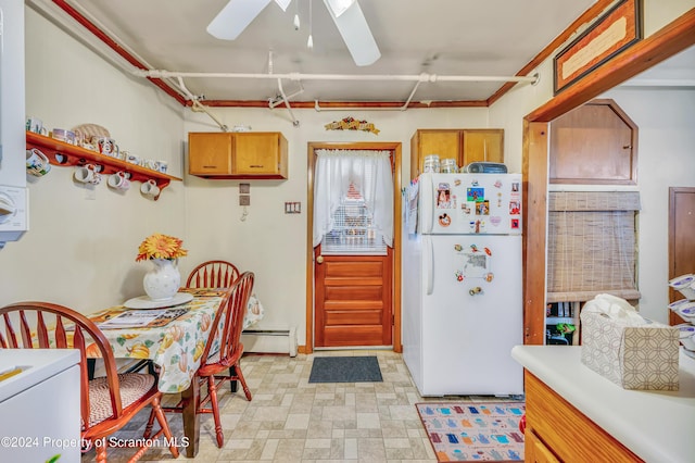 kitchen with ceiling fan, white refrigerator, and baseboard heating