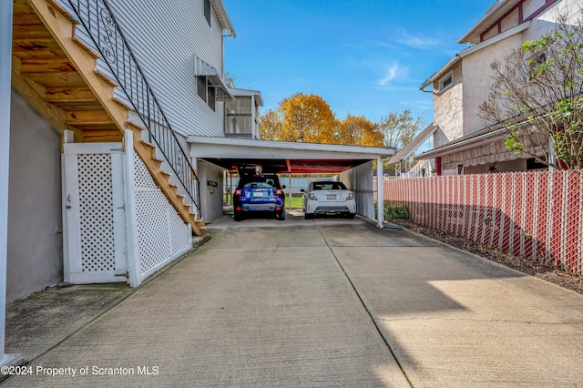 view of parking / parking lot featuring a carport