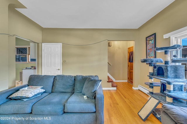 living room with hardwood / wood-style flooring and a baseboard radiator