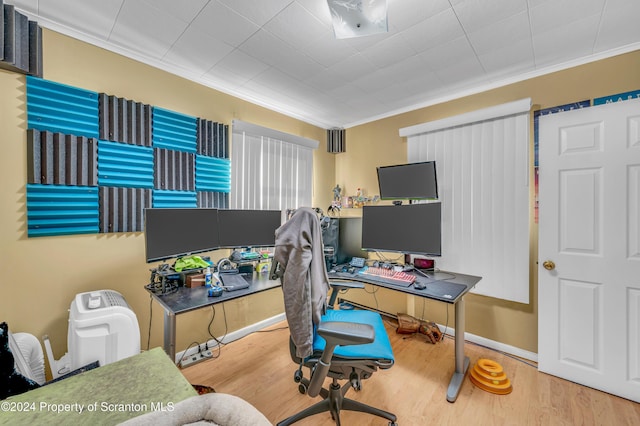 home office featuring hardwood / wood-style floors and crown molding