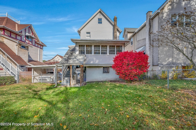 back of house with a lawn