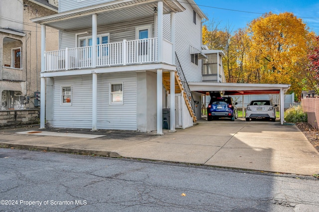 view of front of house with a balcony and a carport