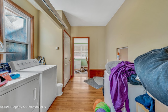 washroom featuring washer and dryer and light hardwood / wood-style flooring