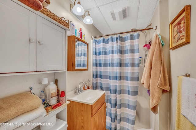 bathroom featuring a paneled ceiling, vanity, and a shower with shower curtain