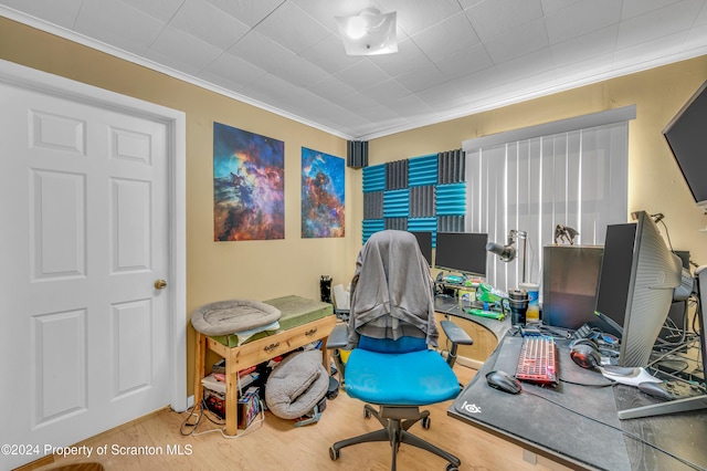 home office featuring hardwood / wood-style flooring and crown molding