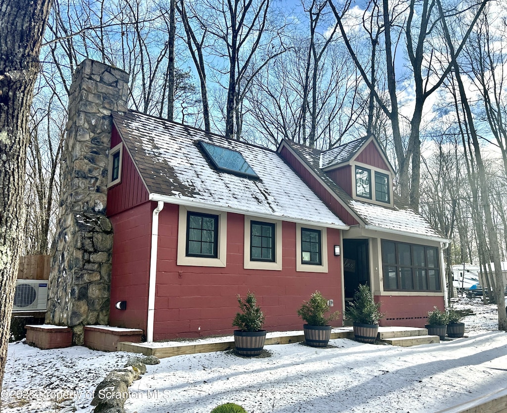 view of front of property featuring a sunroom and ac unit