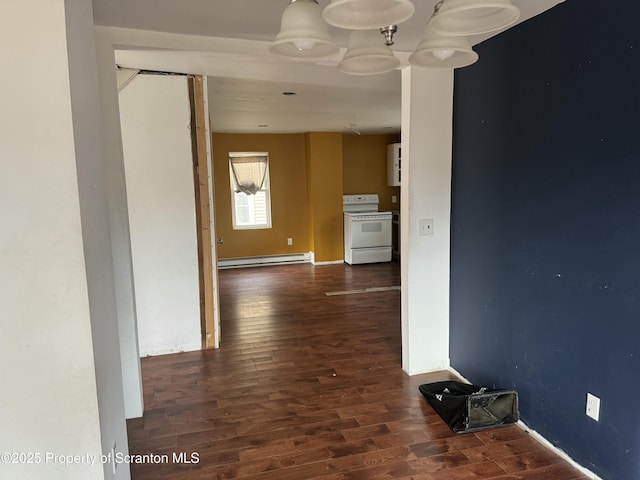 hallway with a baseboard heating unit and wood finished floors