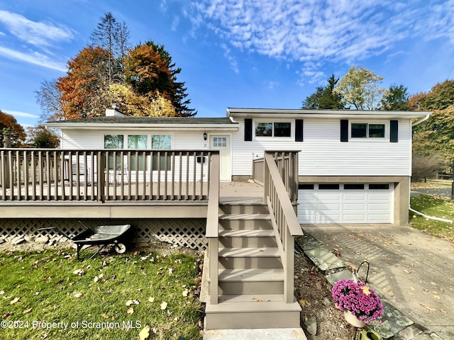 view of front of property featuring a wooden deck and a garage