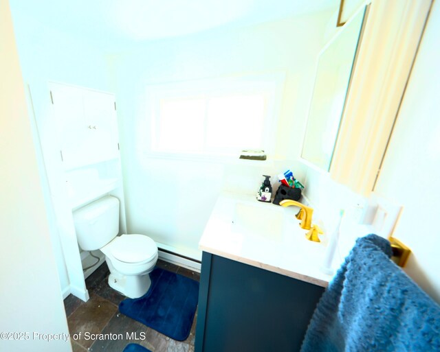 bathroom with vanity, toilet, and a baseboard radiator