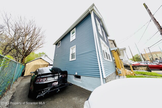 view of side of home with fence