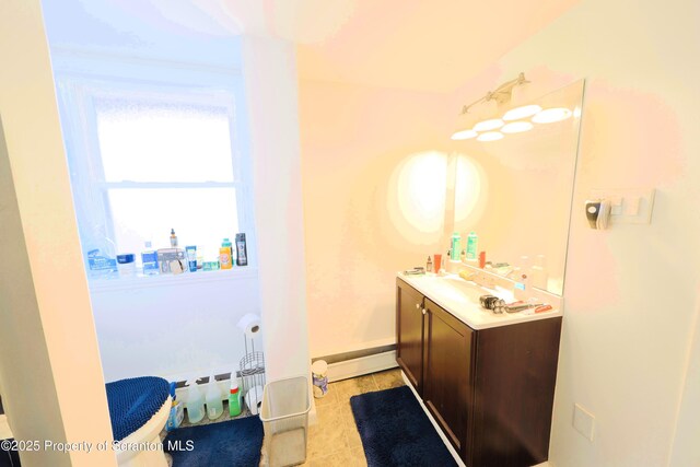 bathroom with vanity, tile patterned floors, baseboards, and a baseboard heating unit