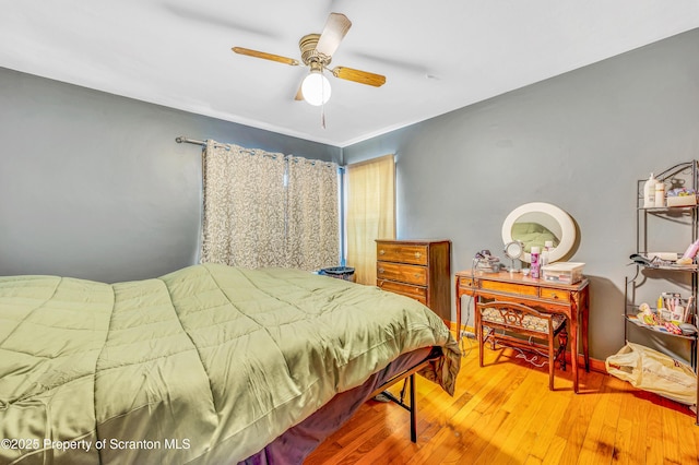 bedroom with hardwood / wood-style flooring and ceiling fan