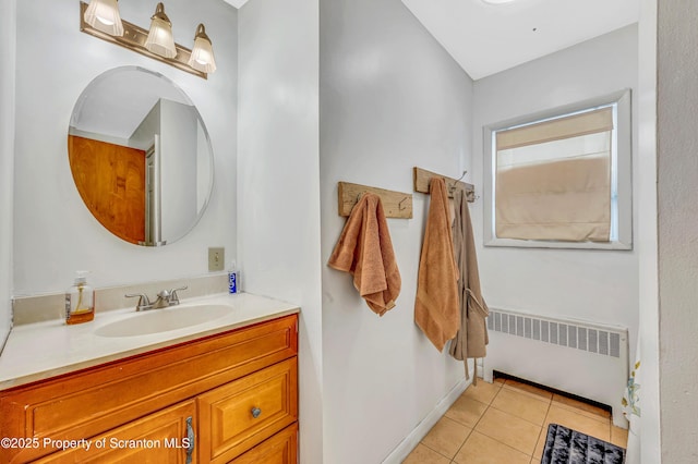 bathroom with tile patterned flooring, vanity, and radiator