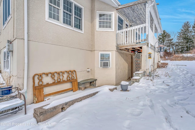 view of snow covered rear of property