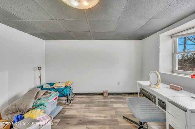 office space with light hardwood / wood-style flooring and a drop ceiling