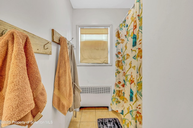 bathroom with radiator and tile patterned floors