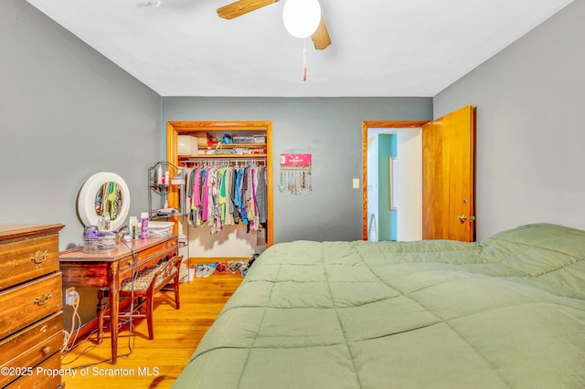 bedroom featuring ceiling fan, light hardwood / wood-style floors, and a closet