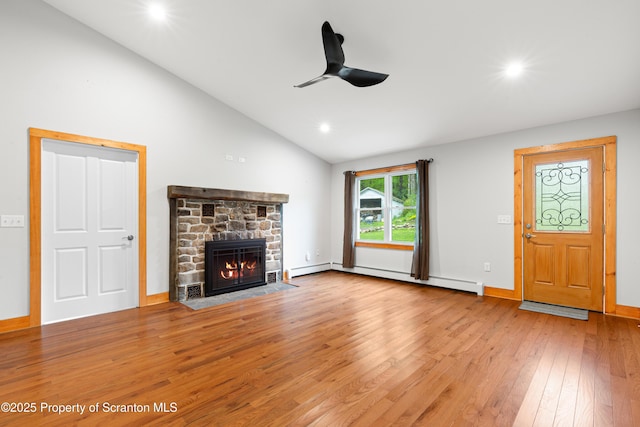 87 Old Farm Ln, White Haven, PA 18661 - unfurnished living room featuring ceiling fan, a baseboard radiator, hardwood / wood-style floors, a stone fireplace, and recessed lighting