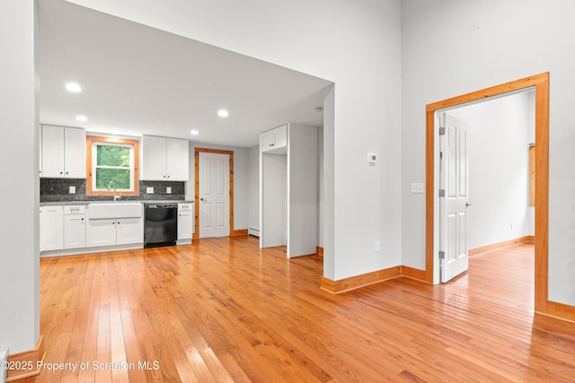 87 Old Farm Ln, White Haven, PA 18661 - kitchen with black dishwasher, light wood finished floors, white cabinetry, decorative backsplash, and baseboards