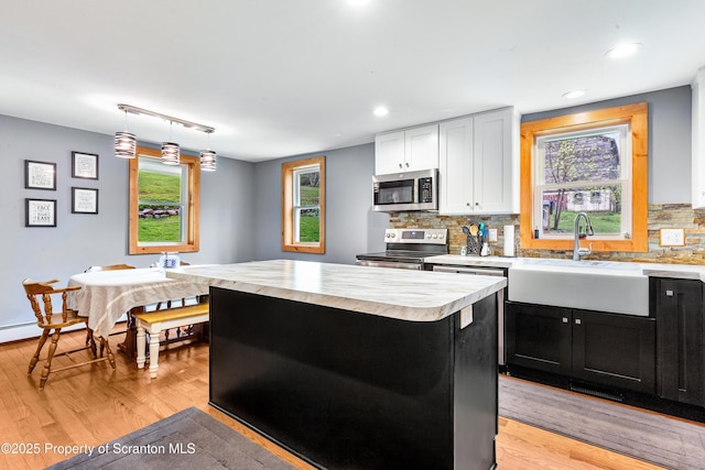 87 Old Farm Ln, White Haven, PA 18661 - kitchen with stainless steel appliances, a sink, light countertops, light wood-type flooring, and recessed lighting