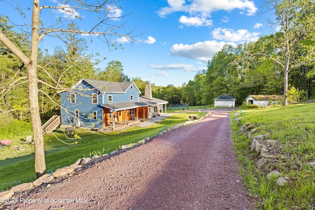 87 Old Farm Ln, White Haven, PA 18661 - view of front of home featuring a chimney, a porch, an outbuilding, a garage, and a front yard