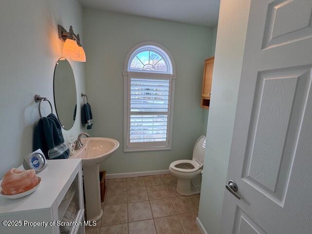 bathroom with tile patterned floors, toilet, and sink