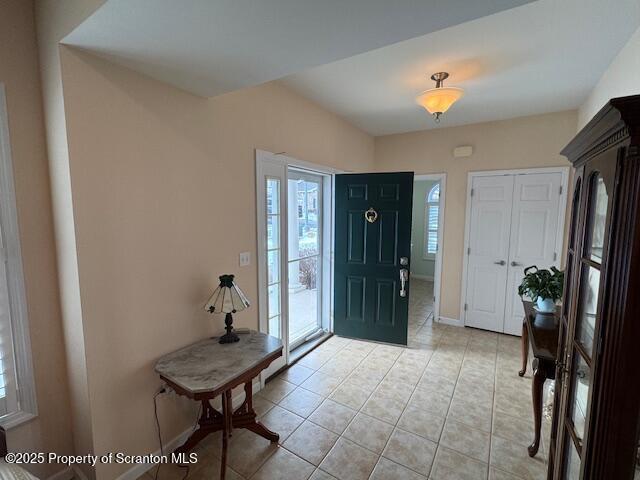 foyer entrance featuring light tile patterned floors