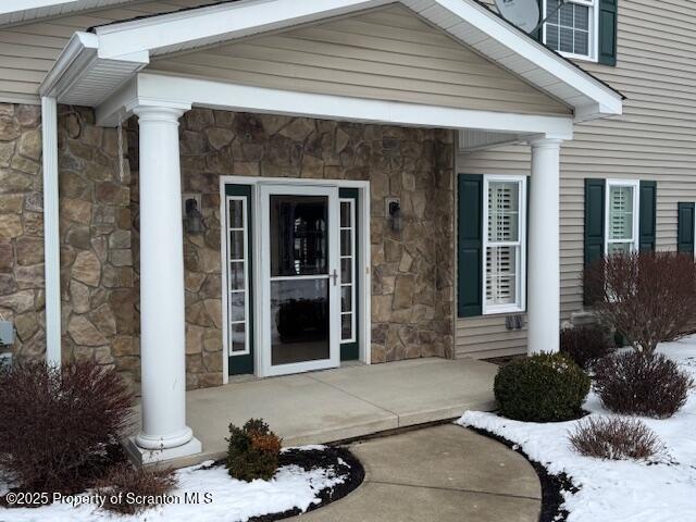 view of snow covered property entrance