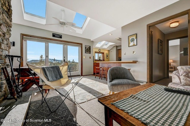 carpeted living room with indoor bar, ceiling fan, and lofted ceiling