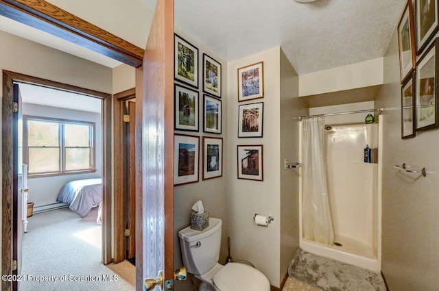 bathroom featuring a shower with curtain and toilet