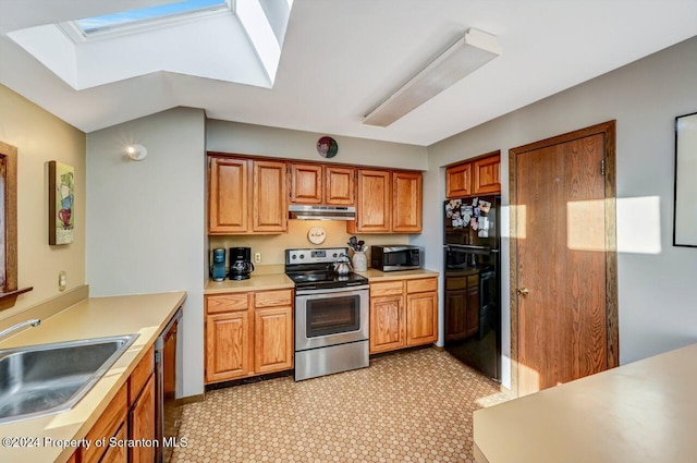 kitchen with a skylight, sink, and appliances with stainless steel finishes