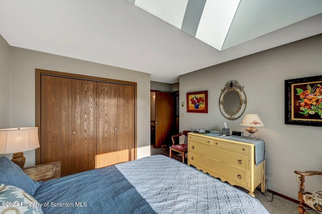 carpeted bedroom with a skylight and a closet