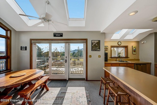 doorway to outside featuring ceiling fan, sink, and vaulted ceiling