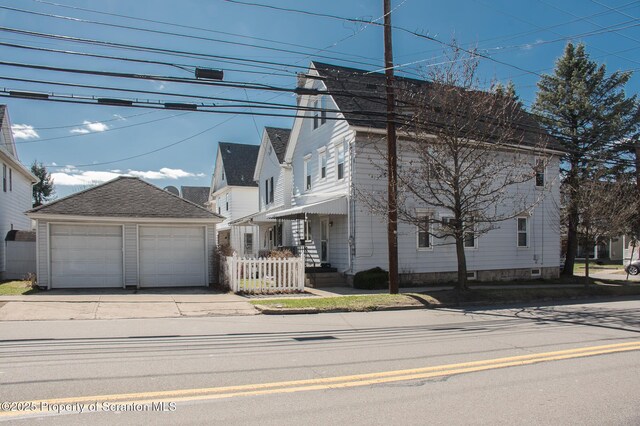 view of home's exterior with an outbuilding and a detached garage