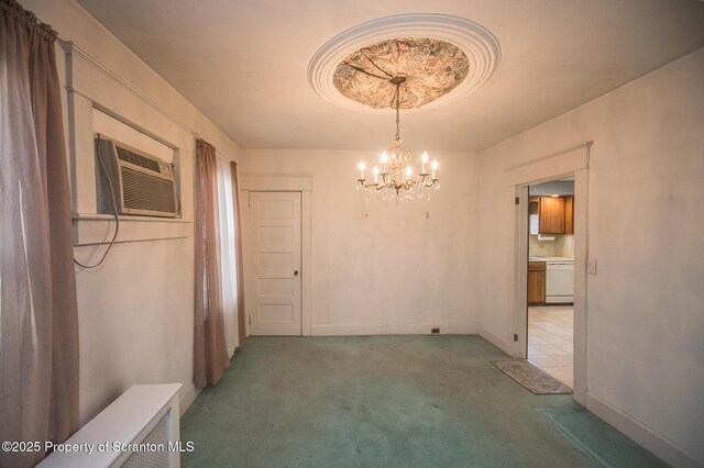 unfurnished dining area with a chandelier, baseboards, a tray ceiling, an AC wall unit, and light colored carpet