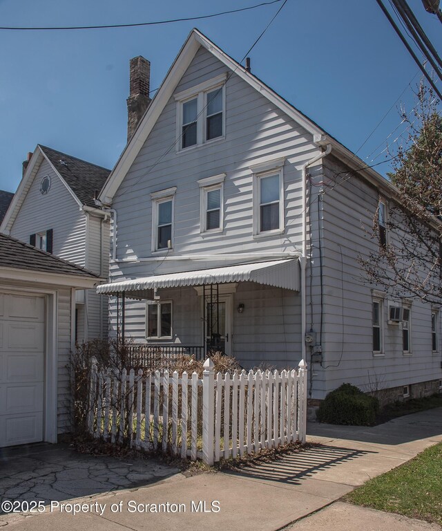 view of front facade featuring a fenced front yard and a chimney