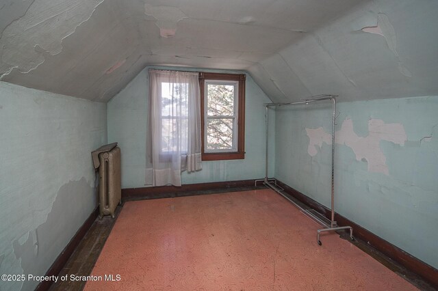 bonus room featuring radiator heating unit, baseboards, and vaulted ceiling