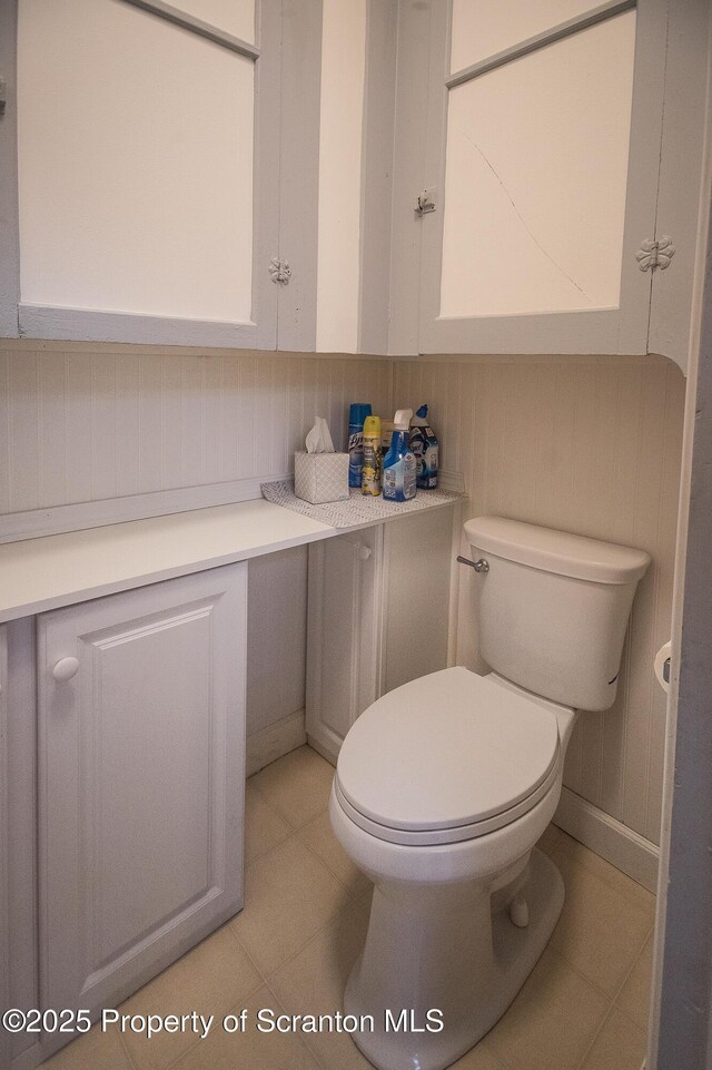bathroom with toilet and tile patterned flooring