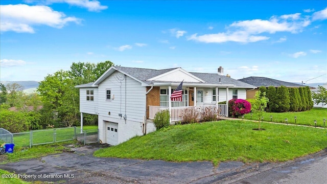 single story home featuring a porch, a garage, driveway, and a chimney