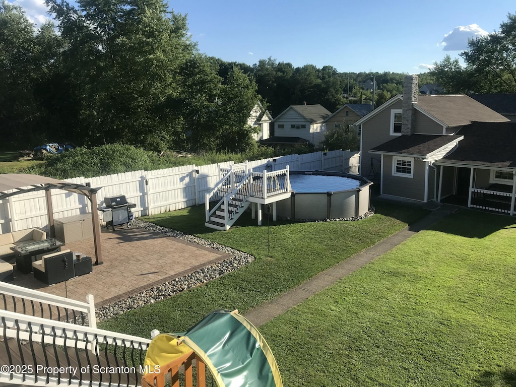 view of yard featuring a fenced in pool and a patio